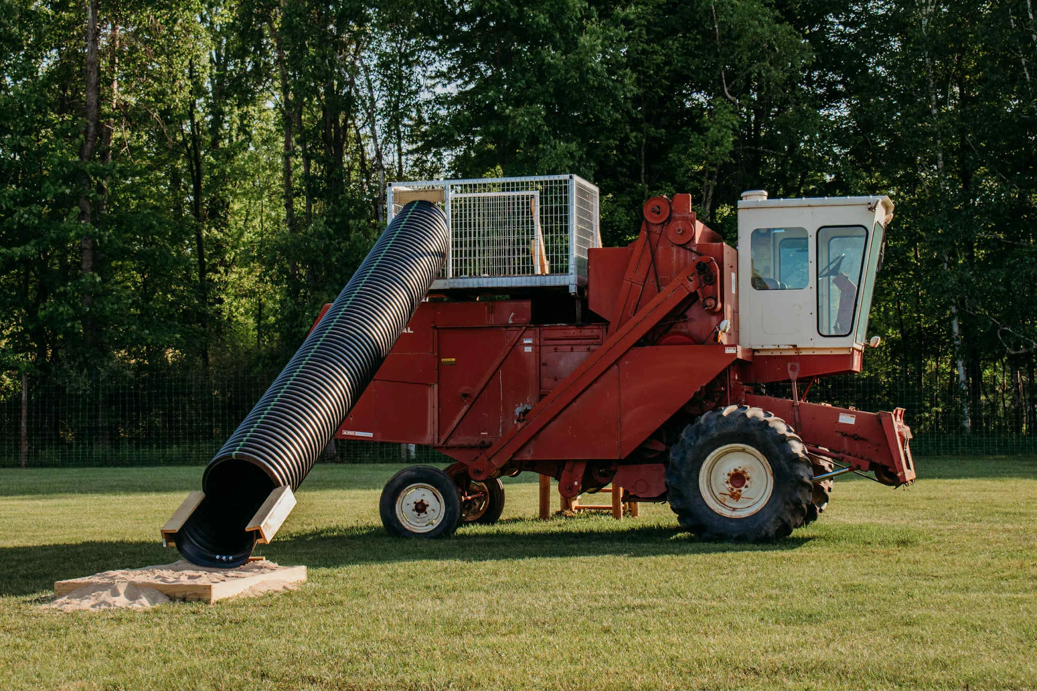 Side view of the retired red combine on the playground